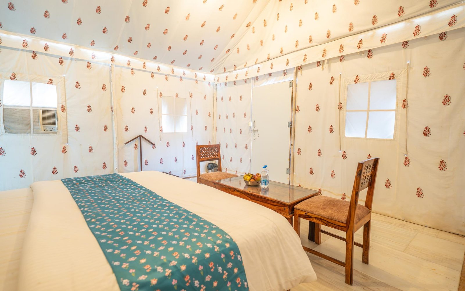 Interior of a Luxury AC Swiss Tent with a window air-conditioning unit and seating table