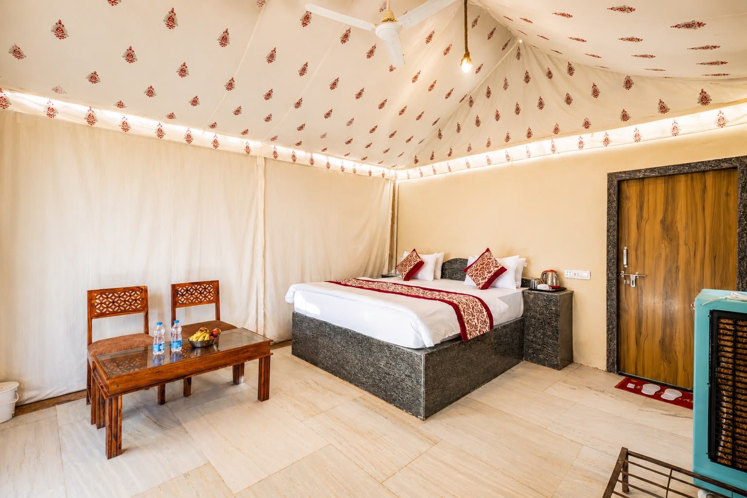 Interior of a traditional Luxury Swiss Tent with block-printed canvas walls and a four-poster bed