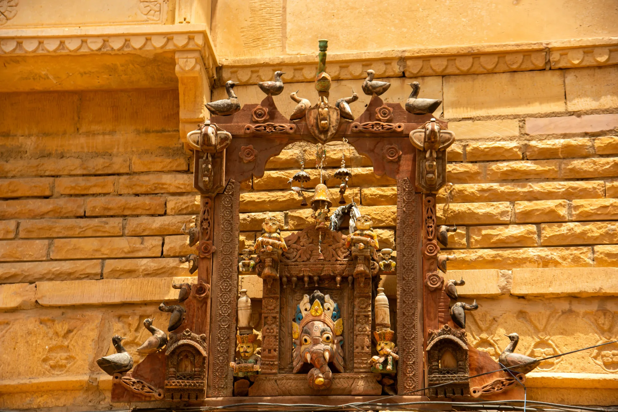 Ornate carved shrine on a Jaisalmer street wall